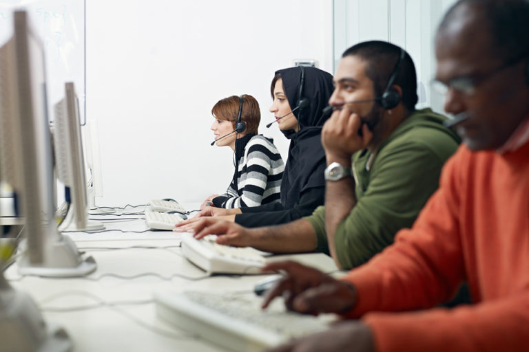 a group of people working at computers