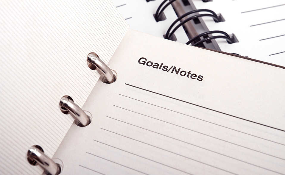 a notebook that says setting goals