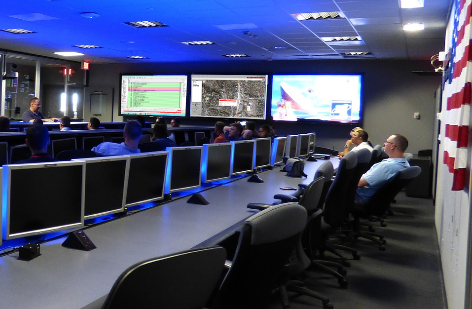 a bunch of computers in a room