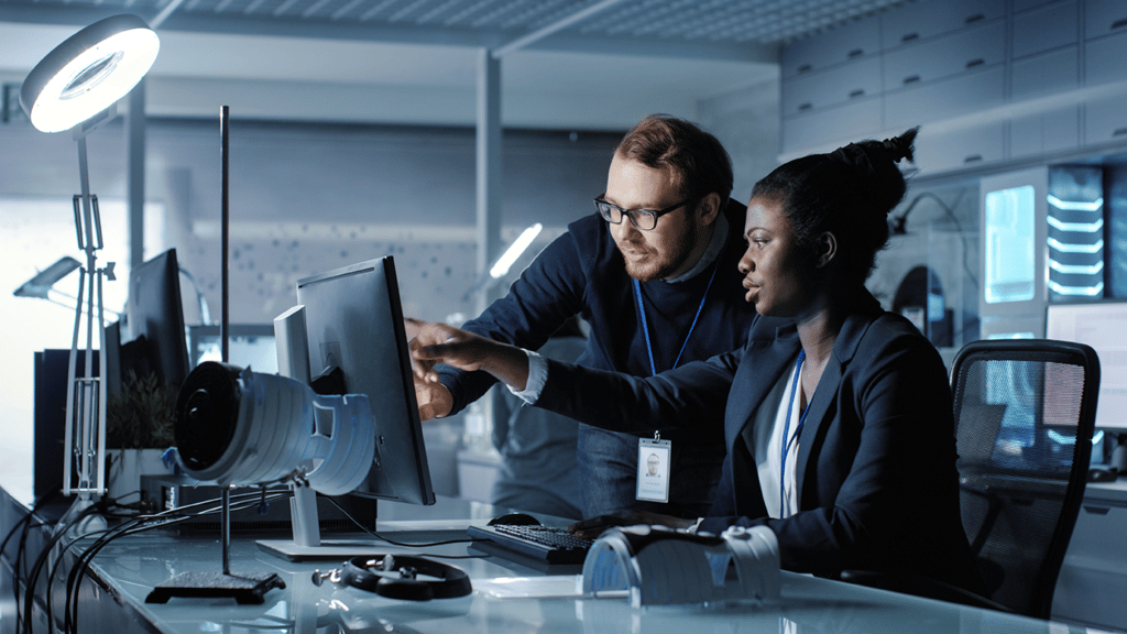 two people working at a computer in the security industry