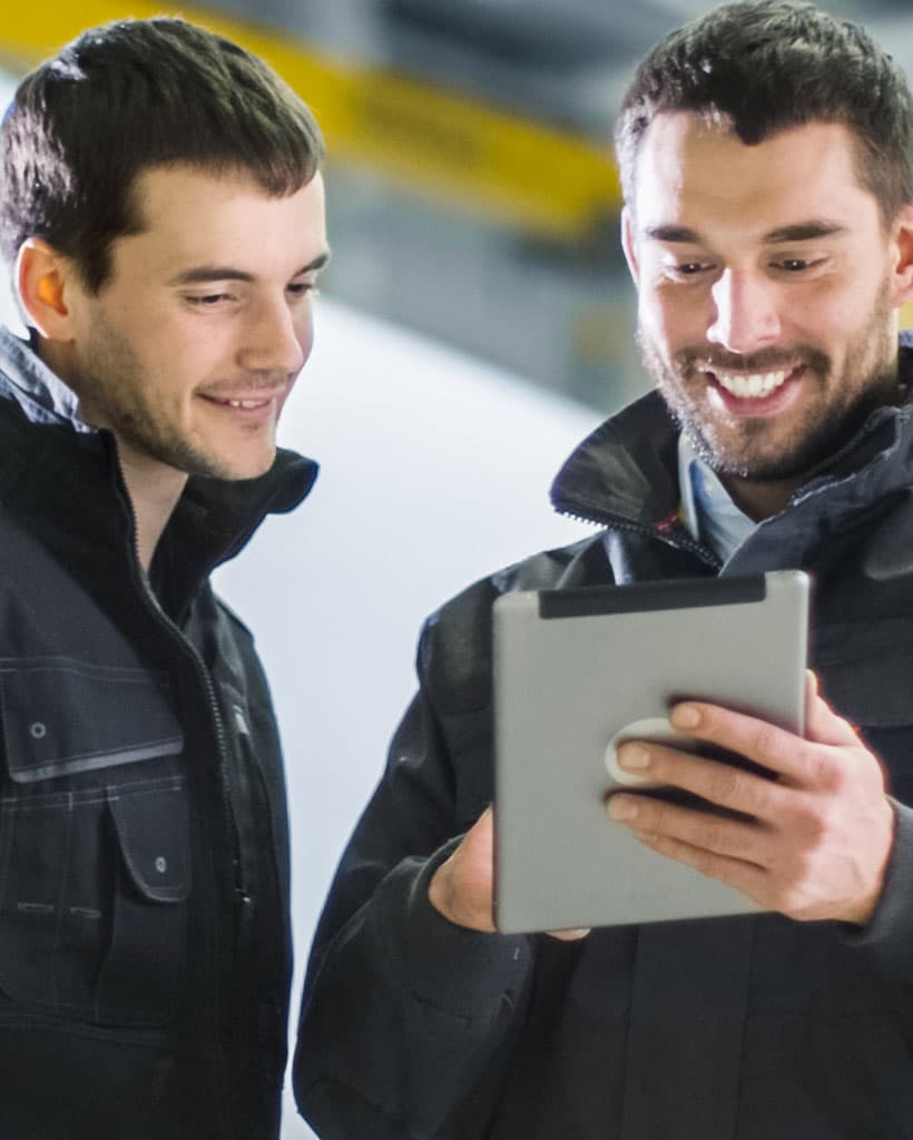 a person pointing to a screen teaching another person 