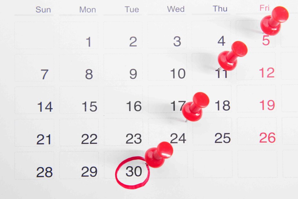 a monthly calendar with push pins in it